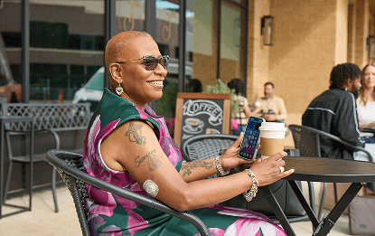 Woman drinking coffee wearing the Dexcom CGM